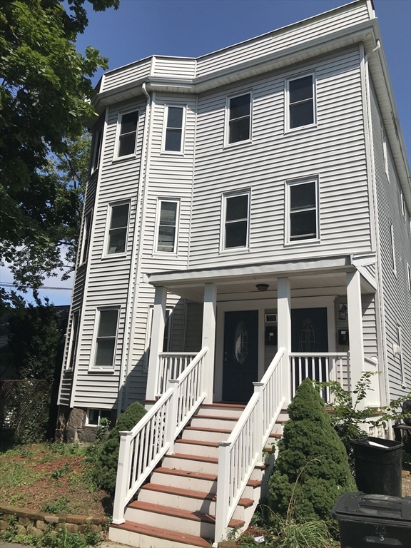 73 Broadway, Unit 3 Quincy, MA 02169 - Photo 1 of 16 a front view of a house with a yard