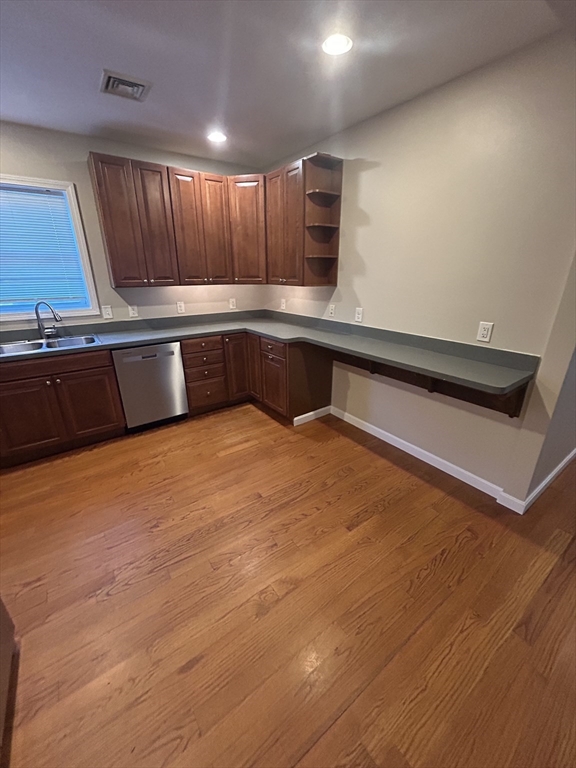 73 Broadway, Unit 3 Quincy, MA 02169 - Photo 3 of 16 a kitchen with stainless steel appliances wooden cabinets and entryway