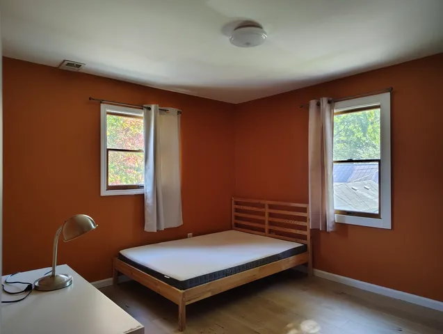 a bedroom with a bed and a window