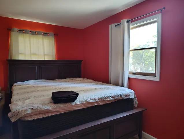 a bathroom with a granite countertop sink toilet a mirror and shower