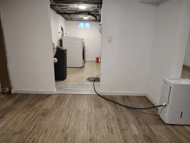 a view of a house with a yard and wooden fence