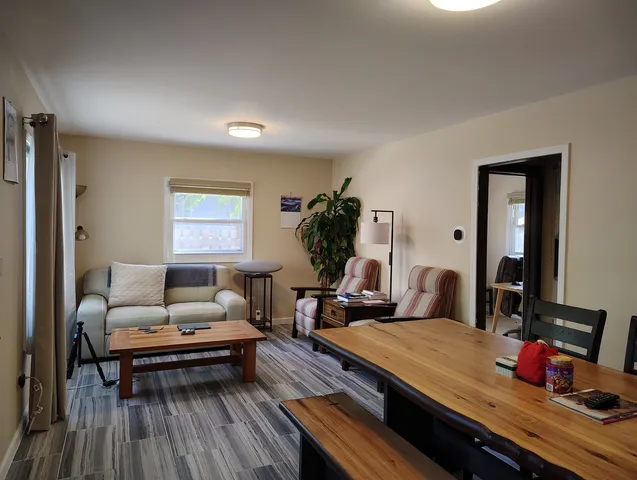 a living room with furniture fireplace and a table