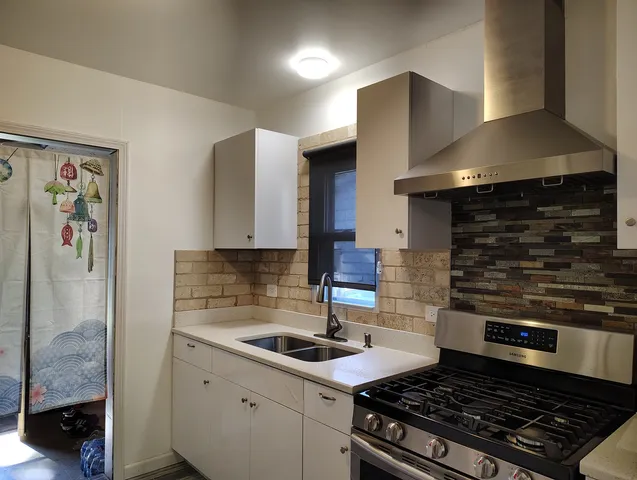 a kitchen with stainless steel appliances granite countertop a stove and a sink