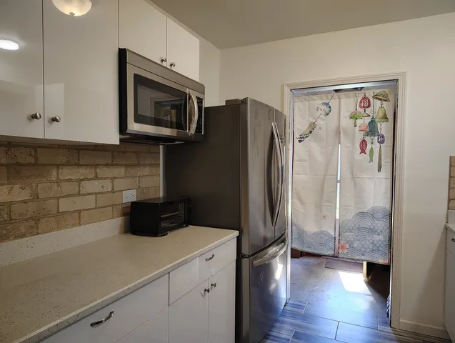 a kitchen with a refrigerator and a stove