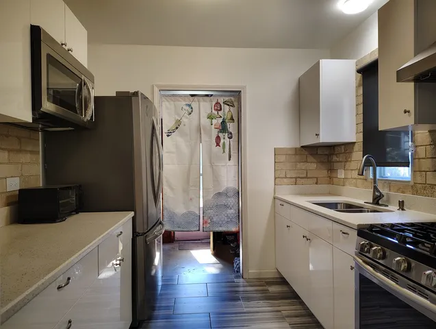 a kitchen with a sink and a stove top oven