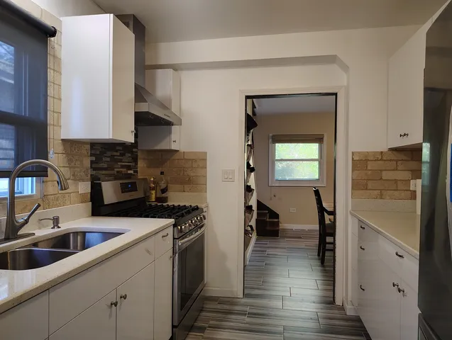 a kitchen with a sink and a refrigerator