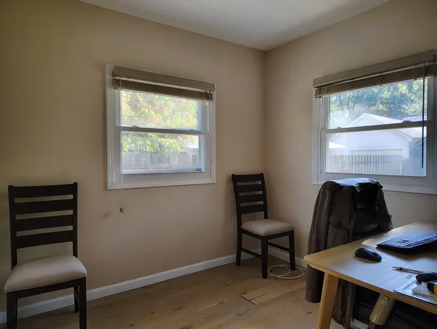 a room with a window and wooden floor