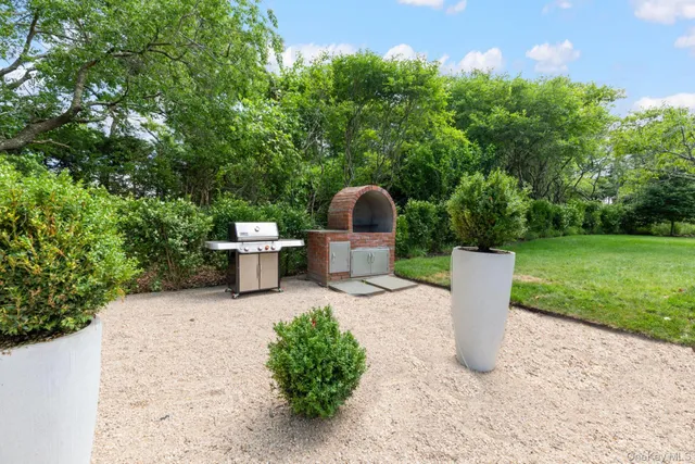 a white bench sitting in the middle of a garden