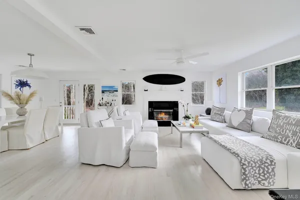 a living room with furniture a fireplace and a large window