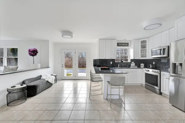 a large white kitchen with cabinets and stainless steel appliances