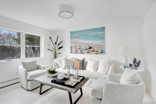a living room with furniture and a potted plant