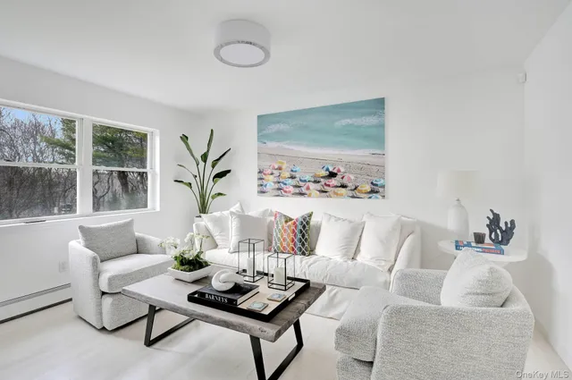 a living room with furniture and a potted plant