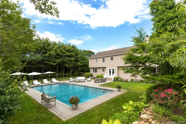 a view of a house with swimming pool and yard