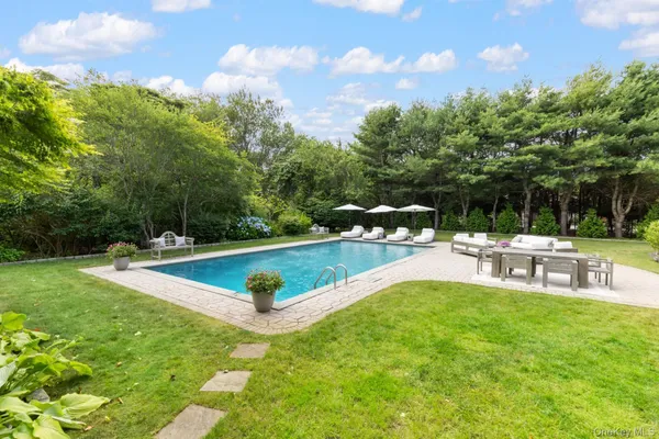 a view of a swimming pool with a table and chairs
