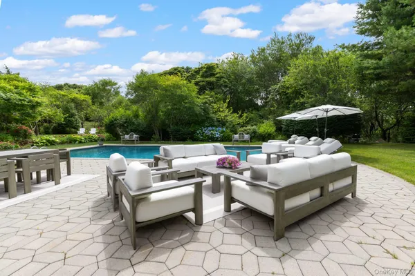 a view of a patio with furniture and a yard