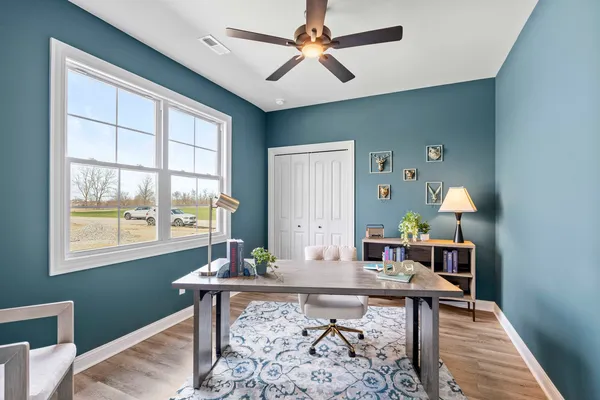 a workspace with furniture window and wooden floor
