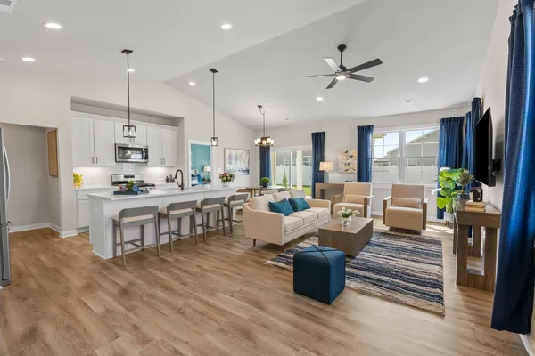 a living room with kitchen island furniture and a kitchen view