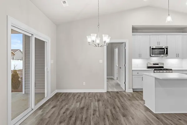 a kitchen with stainless steel appliances granite countertop a refrigerator and a stove top oven