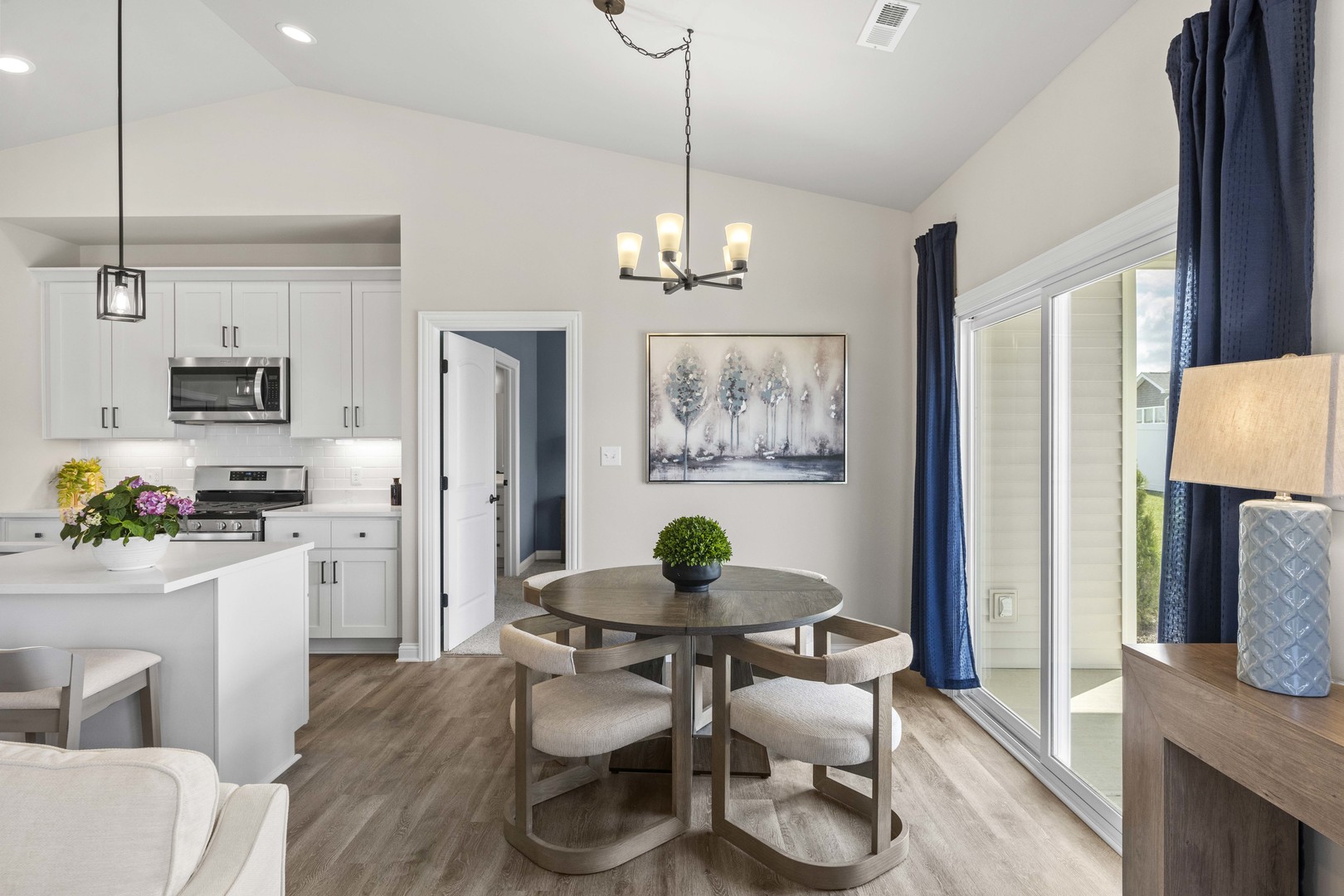 6375 Jasmine Avenue Portage, IN 46368 - Photo 10 of 32 a kitchen with stainless steel appliances a dining table chairs a refrigerator and a window