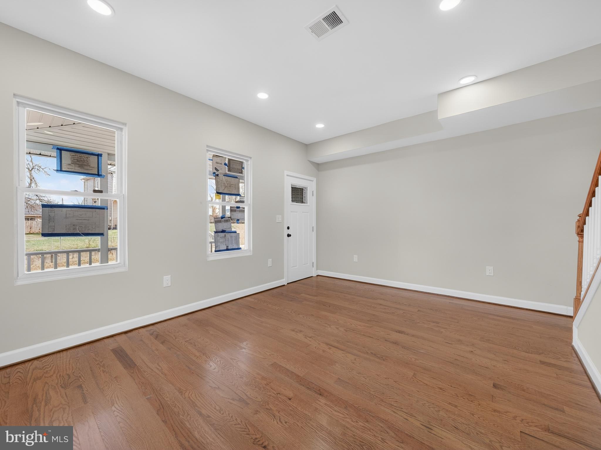 5919 Addison Road Capitol Heights, MD 20743 - Photo 11 of 40 a view of an empty room with wooden floor and a window