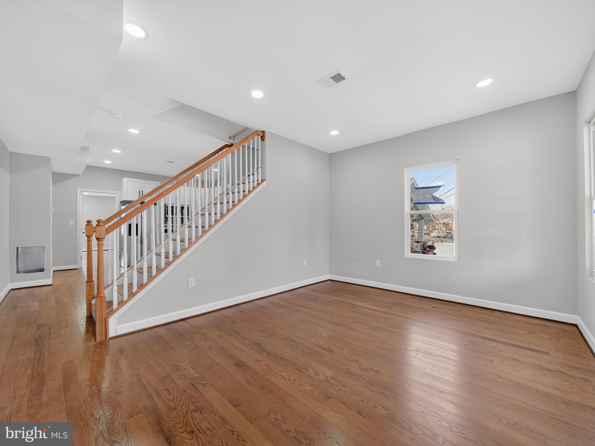 5919 Addison Road Capitol Heights, MD 20743 - Photo 13 of 40 a view of an empty room with wooden floor