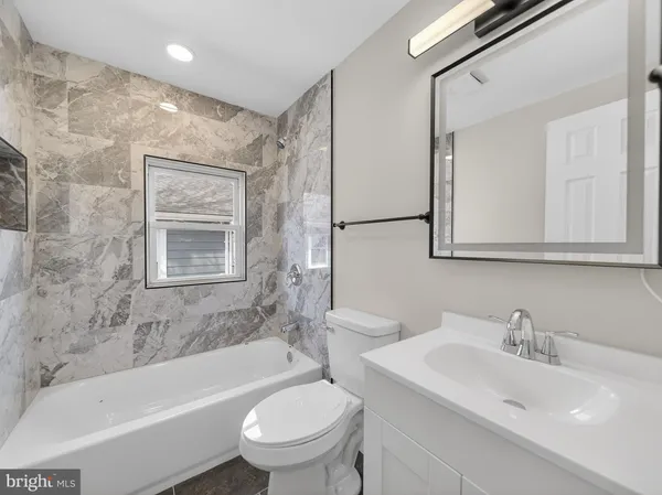 a bathroom with a sink toilet and bathtub