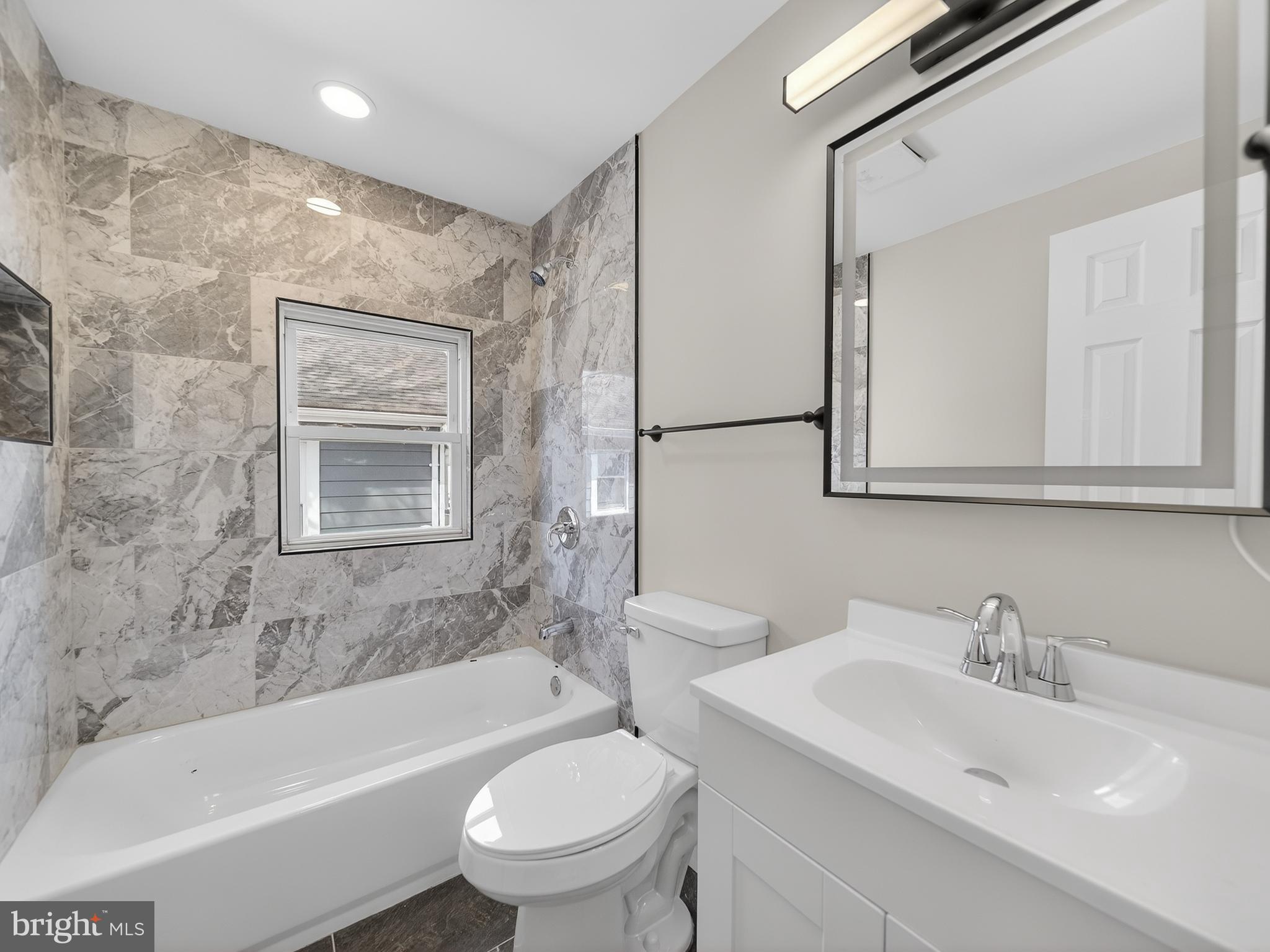 5919 Addison Road Capitol Heights, MD 20743 - Photo 15 of 40 a bathroom with a sink toilet and bathtub