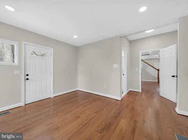 a view of an empty room with wooden floor