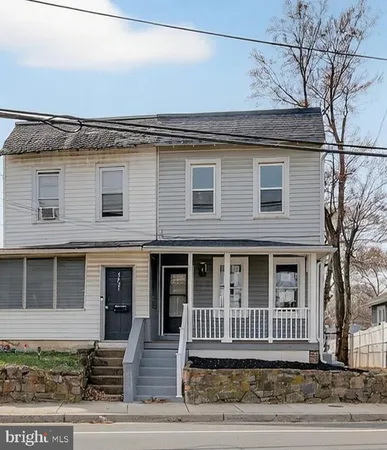 front view of a house with a bench