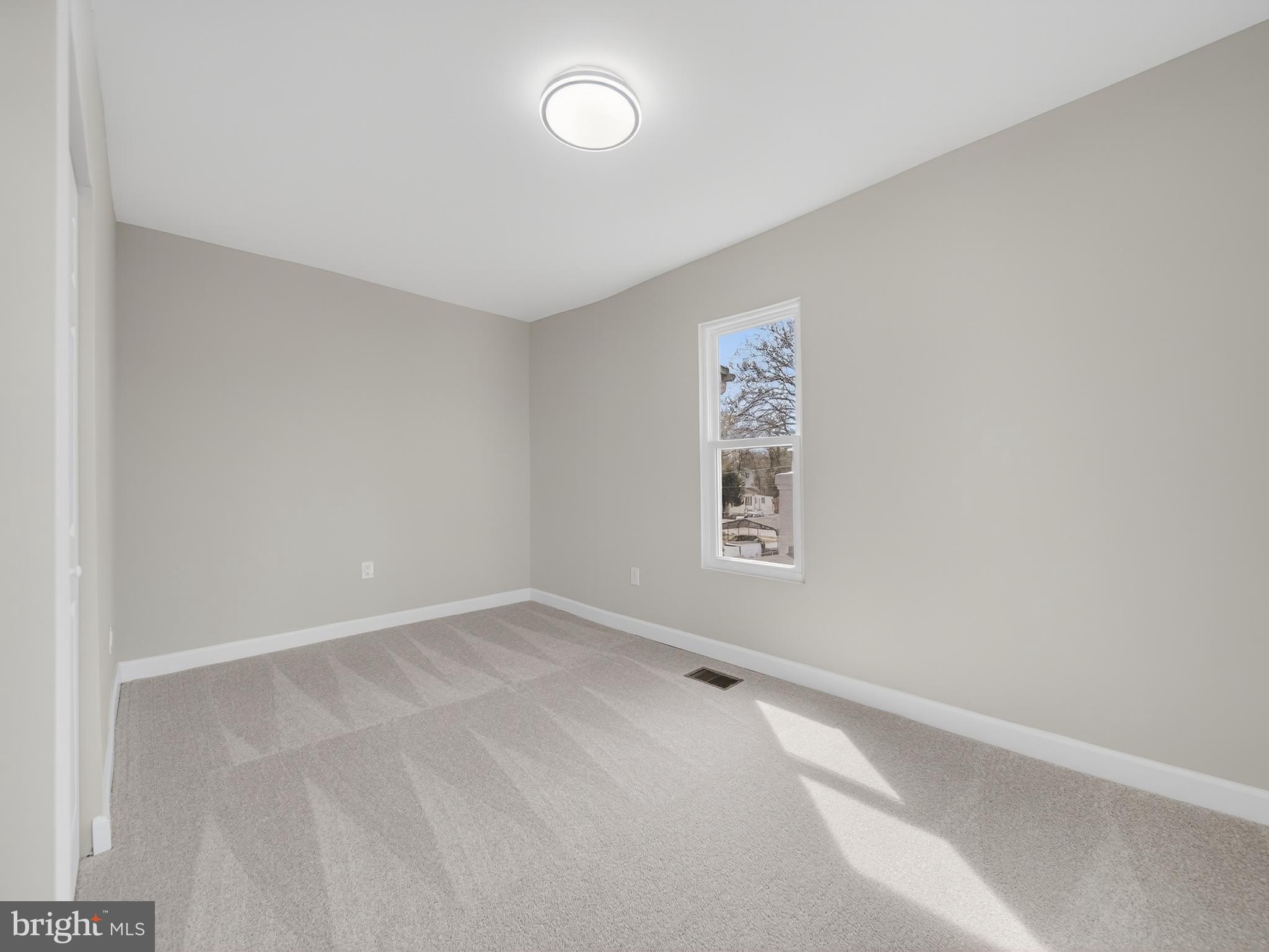5919 Addison Road Capitol Heights, MD 20743 - Photo 21 of 40 an empty room with a empty space and window