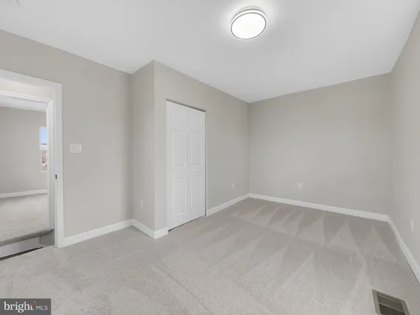 an empty room with a empty space and windows