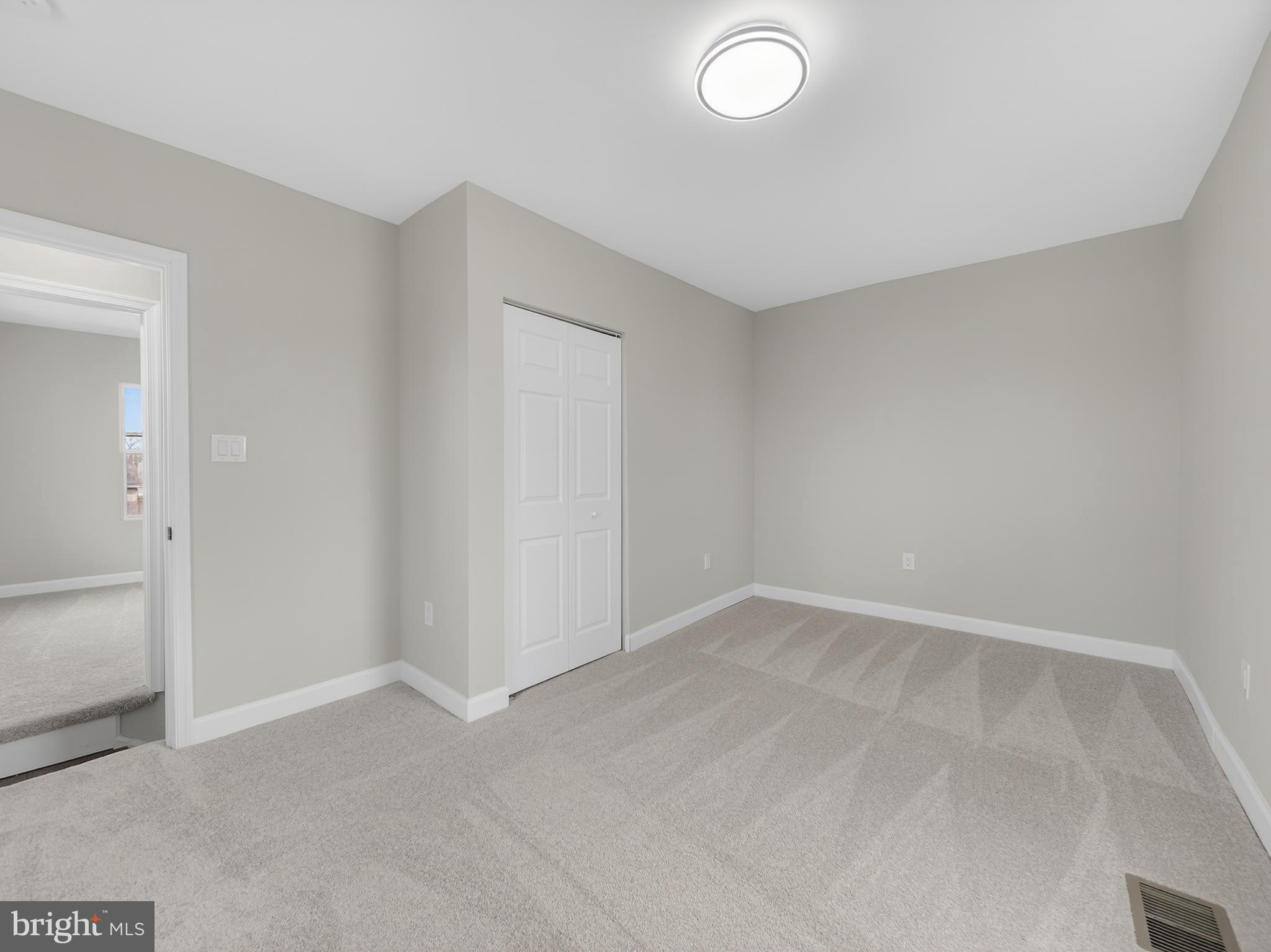 5919 Addison Road Capitol Heights, MD 20743 - Photo 22 of 40 an empty room with a empty space and windows