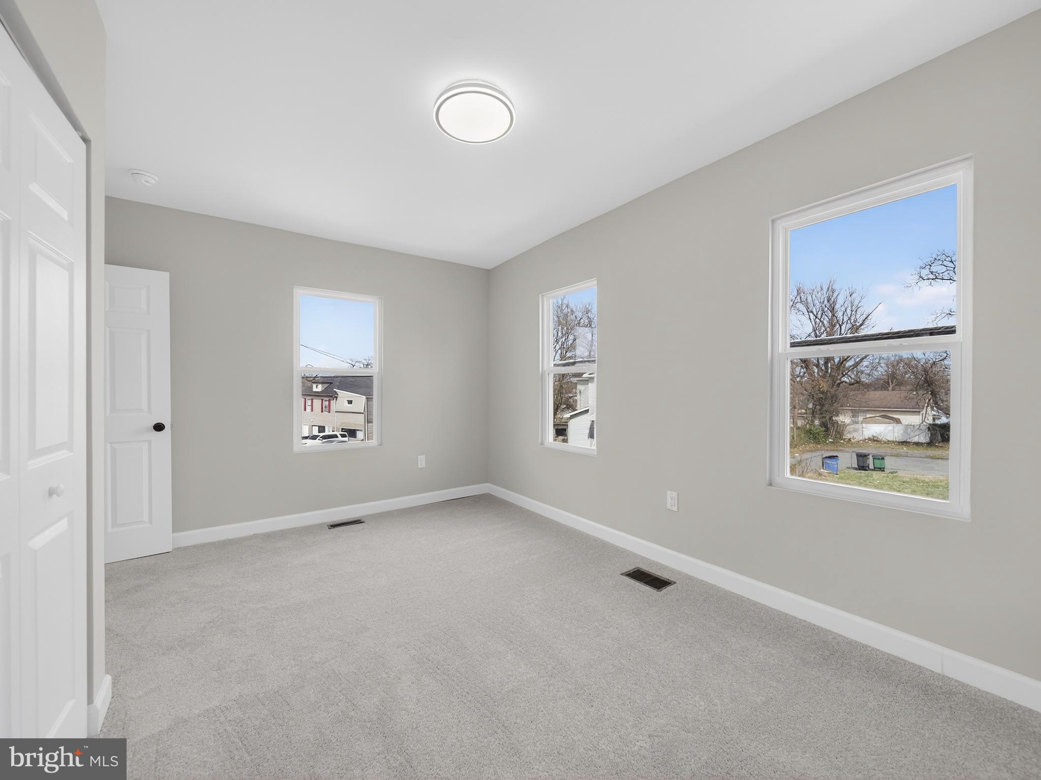 5919 Addison Road Capitol Heights, MD 20743 - Photo 29 of 40 an empty room with windows and closet