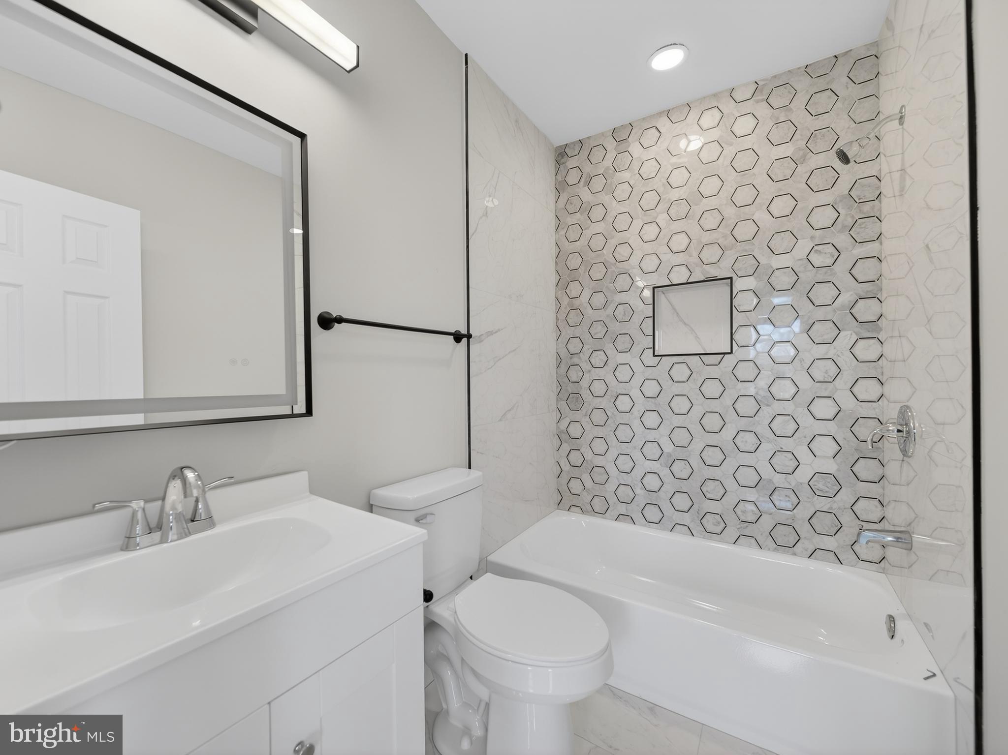 5919 Addison Road Capitol Heights, MD 20743 - Photo 30 of 40 a bathroom with a sink toilet and shower