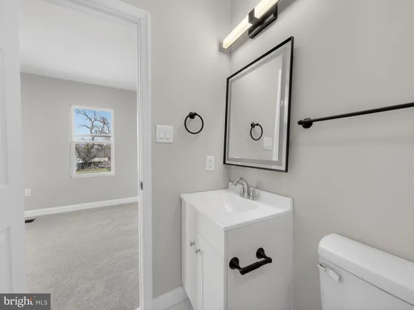 a bathroom with a sink mirror and toilet