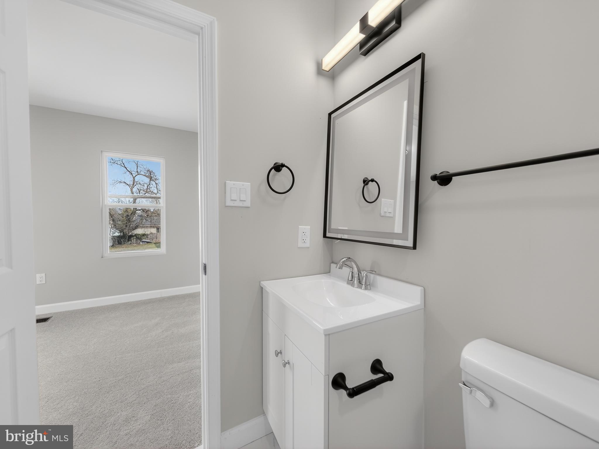 5919 Addison Road Capitol Heights, MD 20743 - Photo 31 of 40 a bathroom with a sink mirror and toilet