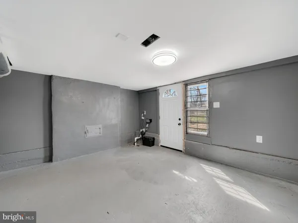 a view of a room with gym equipment and a window