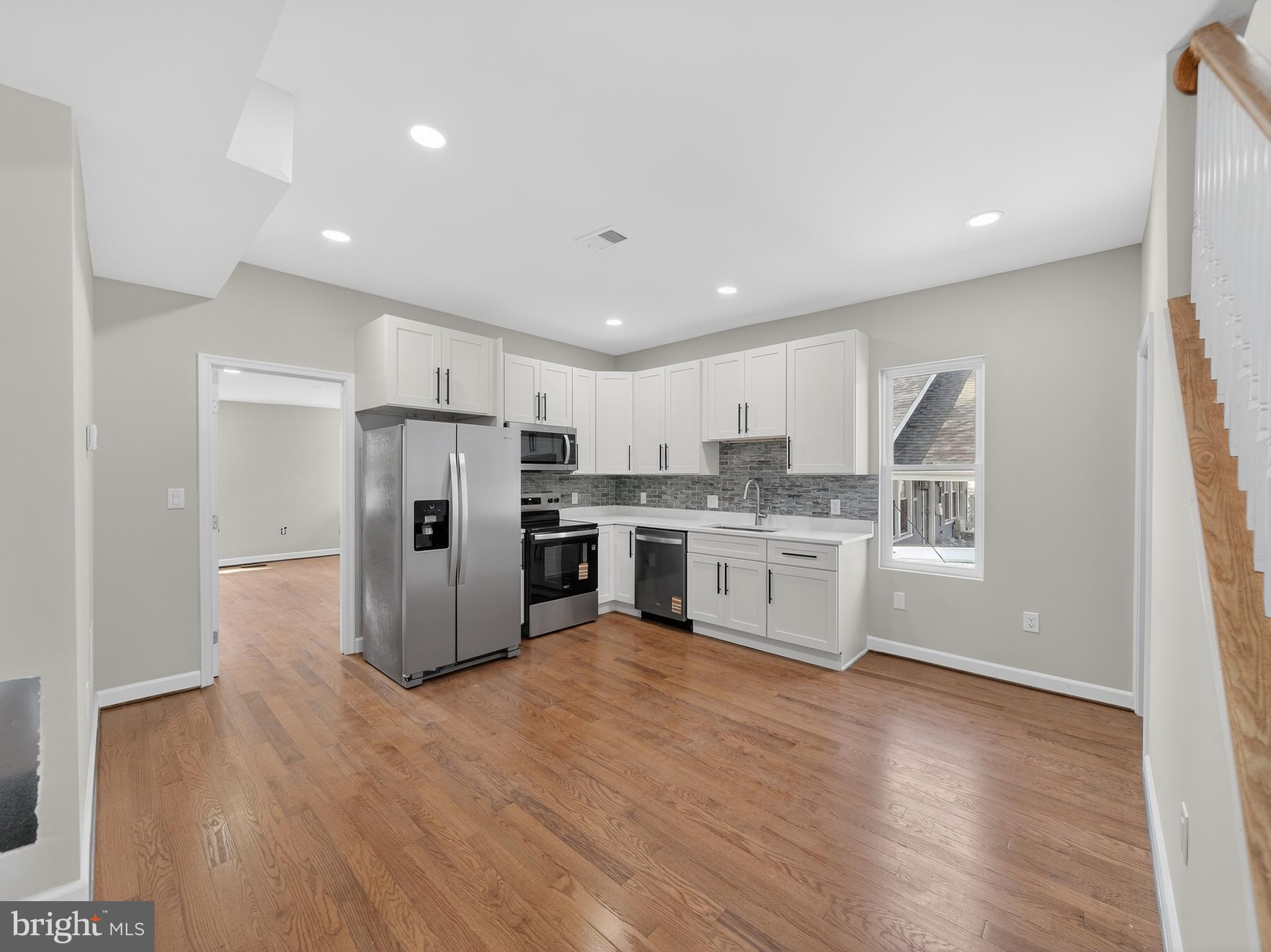 5919 Addison Road Capitol Heights, MD 20743 - Photo 6 of 40 a kitchen with stainless steel appliances a refrigerator sink and cabinets