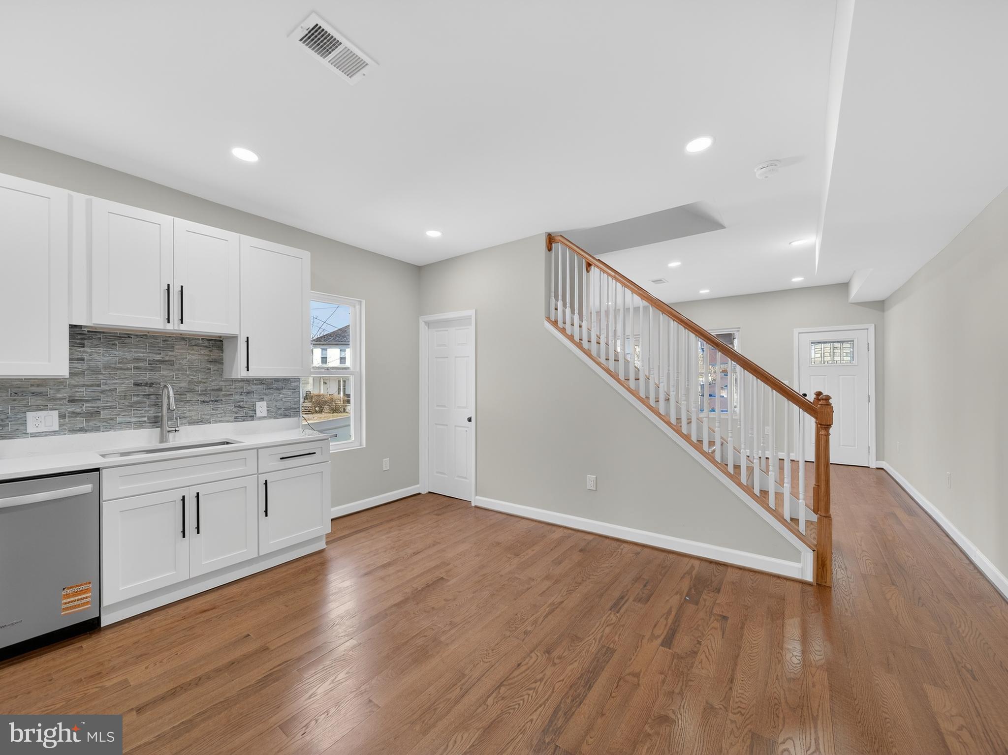 5919 Addison Road Capitol Heights, MD 20743 - Photo 8 of 40 a open hall with cabinets wooden floor and a sink