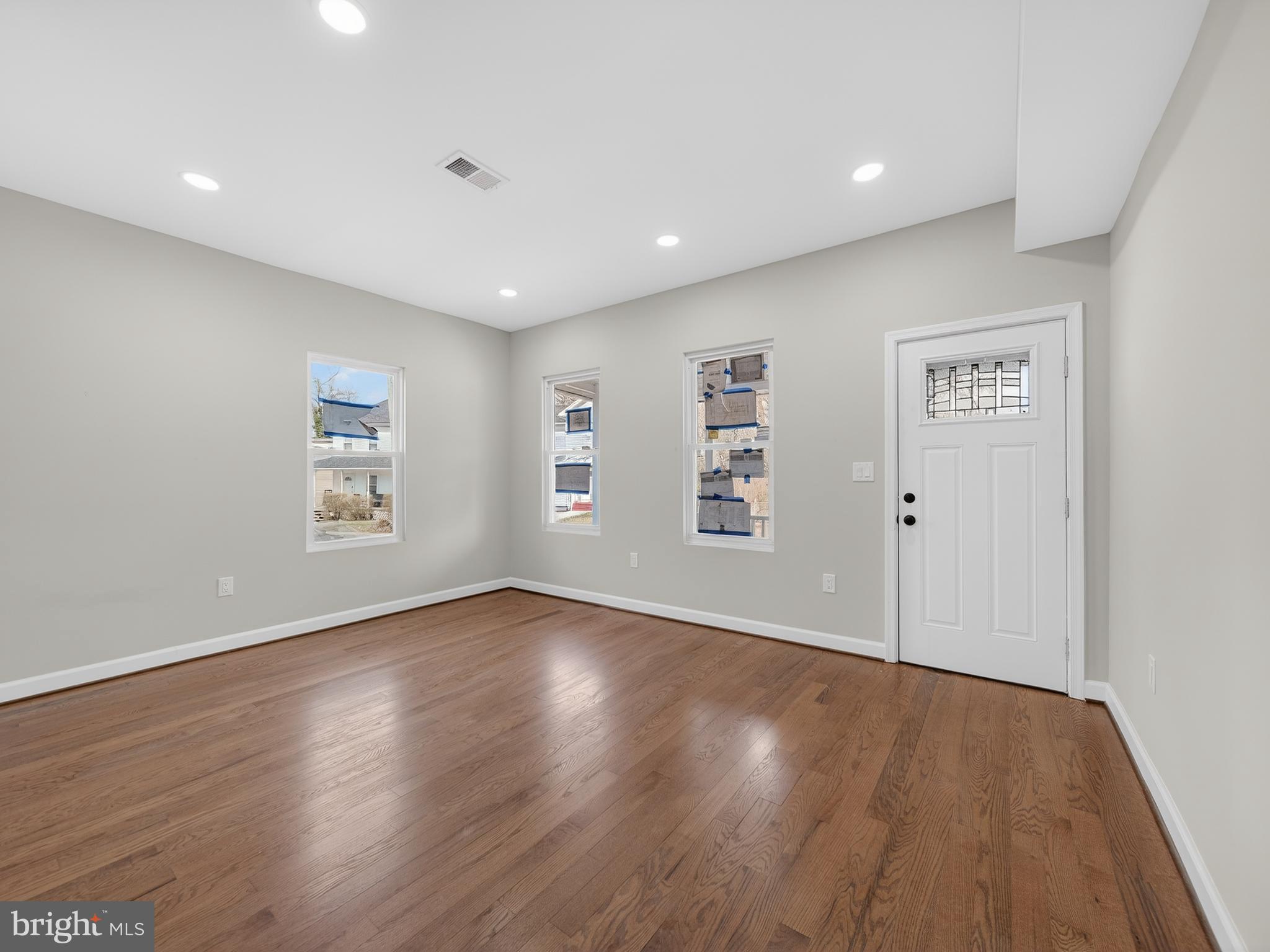 5919 Addison Road Capitol Heights, MD 20743 - Photo 10 of 40 a view of an empty room with wooden floor and a window