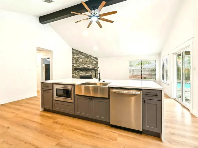 a kitchen with stainless steel appliances granite countertop a stove and a sink