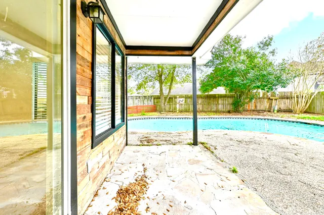 a view of a house with a big yard and potted plants