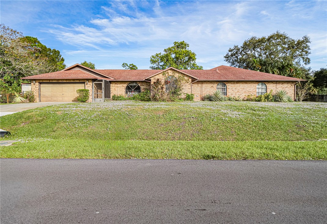 a front view of a house with a yard and garage