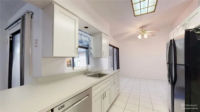 a kitchen with a sink appliances and cabinets