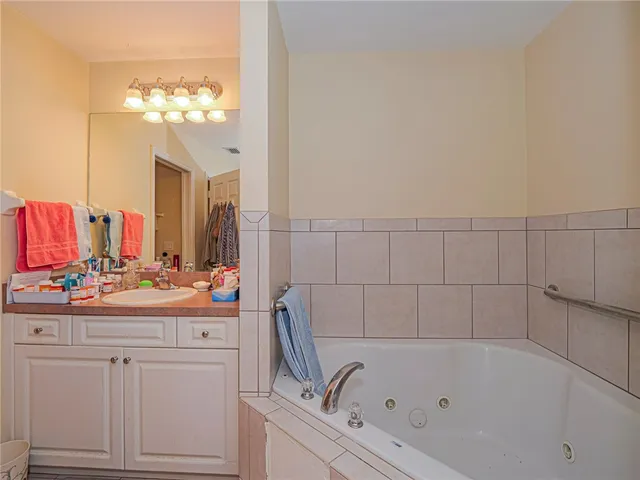a bathroom with a bathtub a sink and a mirror