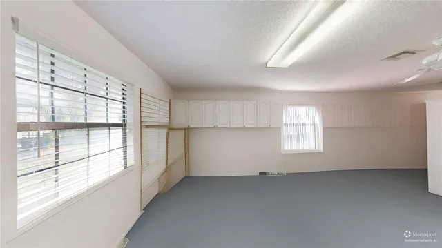 a view of a livingroom with an empty space and window