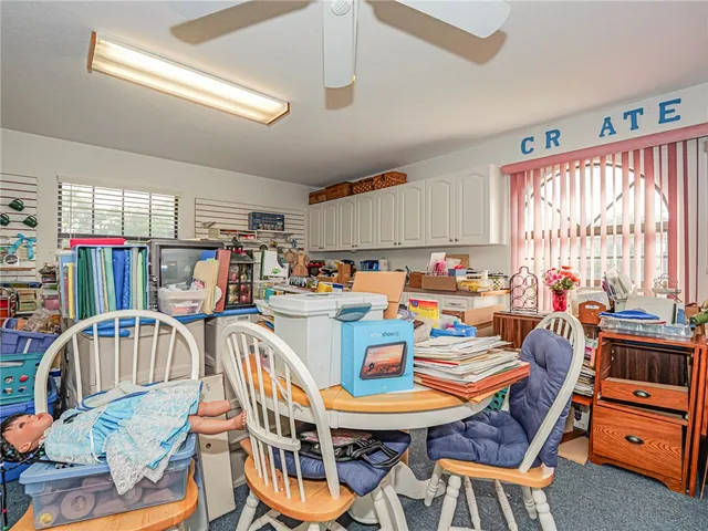 a dining room with furniture a flat screen tv and a window