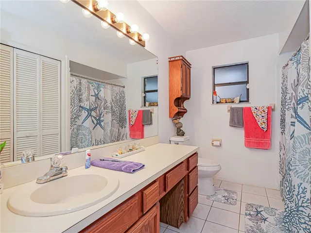 a bathroom with a sink toilet and a mirror