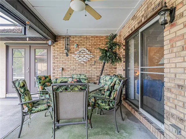 a view of a porch with a table and chairs