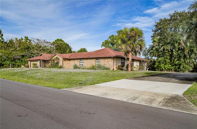 a house with huge green field in front of it
